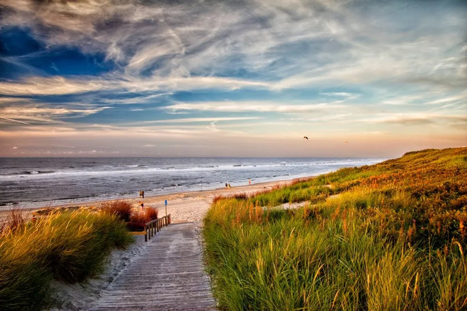 A sandy beach beside calm turquoise water