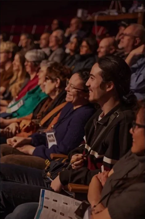 Audience members smiling during Jackie Wu's talk